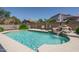 Inviting backyard pool with a rock waterfall feature surrounded by lush landscaping at 5596 W Mercer Ln, Glendale, AZ 85304