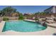 Backyard pool with rock waterfall and mature landscaping offers a private retreat at 5596 W Mercer Ln, Glendale, AZ 85304
