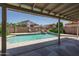 A stunning backyard pool with a waterfall feature and patio furniture offers a relaxing outdoor space at 5596 W Mercer Ln, Glendale, AZ 85304