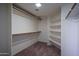 Spacious walk-in closet provides ample storage with shelving and multiple rods at 5596 W Mercer Ln, Glendale, AZ 85304