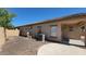 Backyard with an air conditioner, a cement patio, rock and privacy wall at 6908 S 54Th Ln, Laveen, AZ 85339