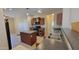 A well-lit kitchen boasts an island and dark countertops at 6908 S 54Th Ln, Laveen, AZ 85339