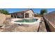 Backyard with a pool and desert landscaping at 6908 S 54Th Ln, Laveen, AZ 85339