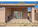 Covered back patio with sliding door, showing some personal items outside at 7310 N 68Th Ln, Glendale, AZ 85303