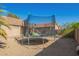 Backyard area featuring a trampoline with a green safety net at 7310 N 68Th Ln, Glendale, AZ 85303