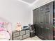 This bedroom features wood-look floors, black closet doors, and storage at 7310 N 68Th Ln, Glendale, AZ 85303