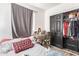 This bedroom features a built-in closet, a desk, and neutral wall paint at 7310 N 68Th Ln, Glendale, AZ 85303