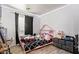 Cozy bedroom showcases a cute pink bedframe and wood-look flooring at 7310 N 68Th Ln, Glendale, AZ 85303