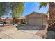 Well-maintained single-story house with a neutral exterior, two-car garage, and desert landscaping in a suburban neighborhood at 7310 N 68Th Ln, Glendale, AZ 85303
