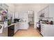 Charming kitchen with grey cabinets, black appliances and an open view to the dining area at 7310 N 68Th Ln, Glendale, AZ 85303