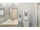 This light-blue bathroom contains a white toilet and vanity, and a shower stall at 742 S Rose --, Mesa, AZ 85204