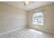 Sunny bedroom featuring stylish floors, ceiling fan, and a view outside the arched window at 742 S Rose --, Mesa, AZ 85204