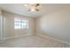 Sun-drenched bedroom with large window, ceiling fan, and tile floors for comfort at 742 S Rose --, Mesa, AZ 85204