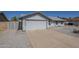 A clean-lined single-story home featuring a two-car garage and a low-maintenance, desert-landscaped front yard at 742 S Rose --, Mesa, AZ 85204