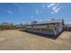 The back of the house shows the yard, sunroom, and covered patio at 742 S Rose --, Mesa, AZ 85204