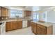 Well-equipped kitchen featuring granite counters, wooden cabinetry, and a view into the sunroom at 742 S Rose --, Mesa, AZ 85204