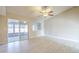 Bright living room with a ceiling fan, tile floors, and a sliding glass door to the patio at 742 S Rose --, Mesa, AZ 85204