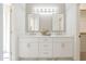 Beautiful bathroom featuring double sinks, quartz counters, decorative mirrors, and modern lighting at 8541 W Sierra Vista Dr, Glendale, AZ 85305