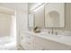Bright bathroom featuring double sinks, quartz counters, decorative mirrors, and modern lighting at 8541 W Sierra Vista Dr, Glendale, AZ 85305