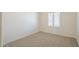 A naturally lit bedroom with neutral carpet and plantation shutters on the window at 8541 W Sierra Vista Dr, Glendale, AZ 85305