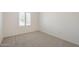 A bright bedroom featuring neutral carpet, plantation shutters, and ample natural light at 8541 W Sierra Vista Dr, Glendale, AZ 85305
