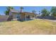 Backyard boasts a covered patio and mature trees, perfect for outdoor living at 8541 W Sierra Vista Dr, Glendale, AZ 85305