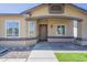 Inviting front entrance with a decorative security door, modern windows, and manicured landscaping at 8541 W Sierra Vista Dr, Glendale, AZ 85305