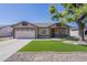 Charming single-story home with a two-car garage, manicured landscaping, and an inviting front porch at 8541 W Sierra Vista Dr, Glendale, AZ 85305