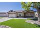 Charming single-story home with a two-car garage, manicured landscaping, and an inviting front porch at 8541 W Sierra Vista Dr, Glendale, AZ 85305