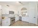 The modern kitchen boasts stainless appliances, white cabinetry, subway tile backsplash, and open view to living room at 8541 W Sierra Vista Dr, Glendale, AZ 85305