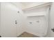An essential laundry room space with white walls and convenient shelving at 8541 W Sierra Vista Dr, Glendale, AZ 85305