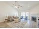 Bright living room features neutral tones, vaulted ceiling, fireplace, and sliding glass door to outdoor living at 8541 W Sierra Vista Dr, Glendale, AZ 85305