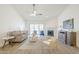 Bright and airy living room with a fireplace, modern furniture, and a sliding glass door at 8541 W Sierra Vista Dr, Glendale, AZ 85305