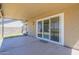 A covered patio with sliding glass doors leads to a grassy backyard at 8541 W Sierra Vista Dr, Glendale, AZ 85305