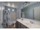 Well-lit bathroom with dual sinks, a shower-tub combination, and tiled flooring at 8964 W Northview Ave, Glendale, AZ 85305