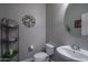Charming half-bathroom featuring a unique vanity, toilet, and stylish decor, perfect for guests at 8964 W Northview Ave, Glendale, AZ 85305