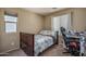 Comfortable bedroom with a twin bed, a bright window, and a desk area perfect for studying at 8964 W Northview Ave, Glendale, AZ 85305