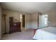 Spacious bedroom with an en suite bathroom featuring neutral paint, carpet flooring, and a view of a tiled shower at 8964 W Northview Ave, Glendale, AZ 85305