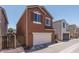 Two-story stucco home featuring a two-car garage and desert landscaping for low maintenance at 8964 W Northview Ave, Glendale, AZ 85305