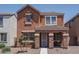 Charming two-story home with a landscaped front yard and stone accents on the entrance columns at 8964 W Northview Ave, Glendale, AZ 85305