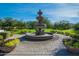 Ornamental tiered fountain surrounded by manicured landscaping and walkways at 8964 W Northview Ave, Glendale, AZ 85305