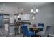 Elegant kitchen and dining area with modern appliances, pendant lighting, and stylish seating at 8964 W Northview Ave, Glendale, AZ 85305
