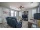 Cozy living room featuring a plush sofa, ceiling fan, and decorative art, creating a welcoming atmosphere at 8964 W Northview Ave, Glendale, AZ 85305