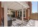 Inviting covered patio featuring a grill, an umbrella, and a pergola with ample seating, ideal for outdoor enjoyment at 8964 W Northview Ave, Glendale, AZ 85305