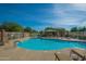 Community swimming pool featuring lounge chairs, a covered seating area, and clear blue water at 8964 W Northview Ave, Glendale, AZ 85305