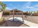 Inviting backyard featuring a gazebo, decorative fountain, and landscaped details at 909 E Harwell Rd, Phoenix, AZ 85042