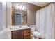 Bathroom featuring a vanity with a mosaic mirror, toilet, and shower with a curtain at 909 E Harwell Rd, Phoenix, AZ 85042