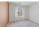 Cozy bedroom with a large window providing a view of the neighborhood at 909 E Harwell Rd, Phoenix, AZ 85042