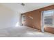 Spacious bedroom with carpet and two windows providing natural light at 909 E Harwell Rd, Phoenix, AZ 85042