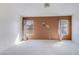 Bedroom with carpet and two windows providing natural light at 909 E Harwell Rd, Phoenix, AZ 85042